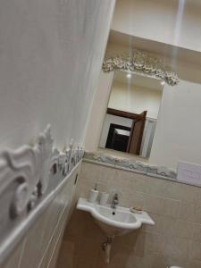 a bathroom with a sink and a mirror at Villa laura in Palermo