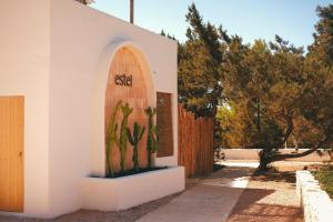 a house with a cactus on the side of it at Estel Formentera in Playa Migjorn