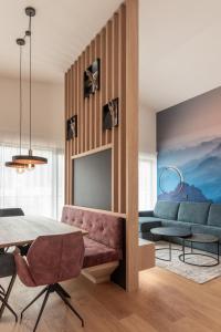 a living room with a couch and a table at Luxury Penthouse - Between Kronplatz, 3 Peaks Dolomites and Lake Prags in Monguelfo