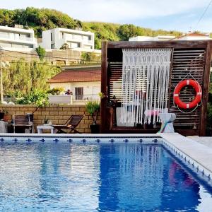 uma casa com piscina com chuveiro em Porto Dinheiro Beach I em Lourinhã