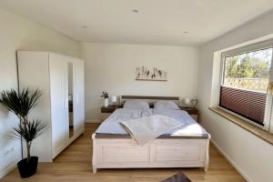 Postel nebo postele na pokoji v ubytování Ferienwohnung Nordlicht