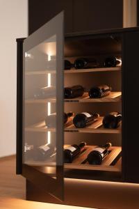 a refrigerator filled with lots of bottles of wine at Luxury Penthouse - Between Kronplatz, 3 Peaks Dolomites and Lake Prags in Monguelfo