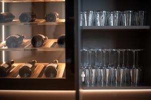 a refrigerator filled with wine bottles and glasses at Luxury Penthouse - Between Kronplatz, 3 Peaks Dolomites and Lake Prags in Monguelfo +23 photos