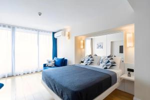 a bedroom with a large bed with blue and white pillows at Batumi Orbi City in Batumi