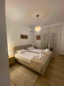 a bedroom with two beds and a chandelier at Eva's Suite in Serres