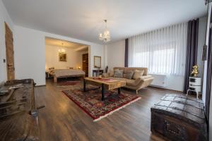 a living room with a couch and a table at Doa Boutique Hotel in Peje