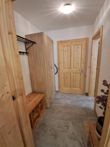 a room with wooden doors and a room with a bench at Appartement mit Hallenbad in Sankt Martin bei Lofer