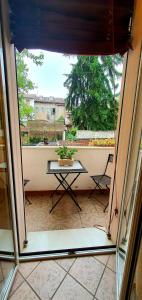 a view from a window of a balcony with a table at D'Elite Room & Breakfast in Ferrara