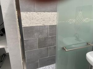 a bathroom with a shower with a glass door at 3 BR TH fee Parking Walk 2 Metro in Washington