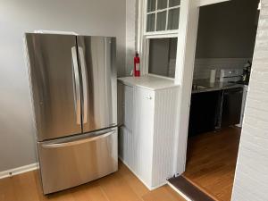 a kitchen with a stainless steel refrigerator and a counter at 3 BR TH fee Parking Walk 2 Metro in Washington