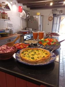 a kitchen counter with two pizzas on a table at Montana retreat in Alora