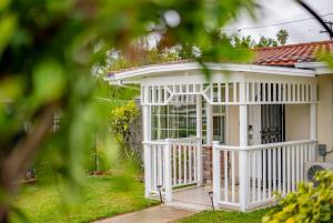 a white house with a white front porch at Peaceful Family Home with 3 Bedrooms and 2 Bathrooms in Glendora