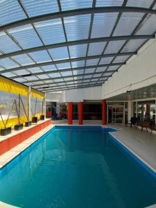 a large swimming pool with a ceiling at Santa Teresita Apartments by San Remo in Santa Teresita
