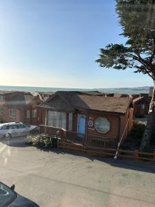 a house with a car parked in front of it at Private Cabin 21 with Jacuzzi Pet Friendly in Smith River