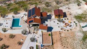 an aerial view of a house with a pool at Holiday house OLIVE LAND in Gustirna