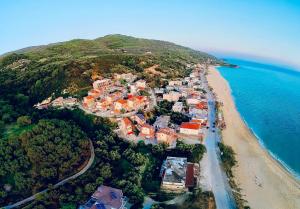 an aerial view of a village on a beach at Vrachos Beach Villa in Loutsa