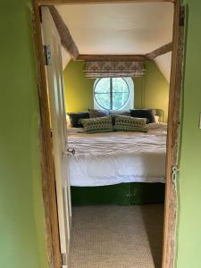 a bedroom with a large bed with a window at Swan Farm in Daventry