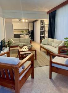 a large living room with couches and tables at Green Garden Guest House in Famagusta +26 photos
