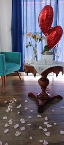 a room with a table with a red seat and flowers on the floor at Pousada Sonho do Campo in São Pedro