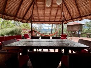 a black table and chairs in a pavilion with a playground at Valle Verde Lodge - Vista in Samaipata
