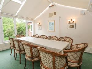 a dining room with a table and chairs at Rosehill Manor in Market Drayton