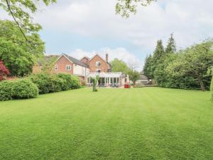 a large lawn in front of a house at Rosehill Manor in Market Drayton