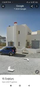 a car parked in a parking lot in front of a building at Casa di Calma in Ermoupoli