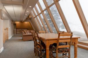 a dining room with a table and some windows at Legacy Vacation Resorts Steamboat Springs Hilltop in Steamboat Springs