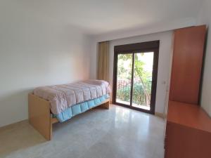 a room with a bed and a door with a window at Paraíso Galera - Apartamento con piscina in Estepona +24 photos