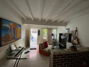 a living room with a couch and a television at Casa Mi Valle Loft in Santa Marta