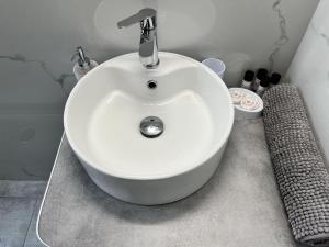 biała umywalka z kranem w łazience w obiekcie Deseo 2 Apartments w Atenach