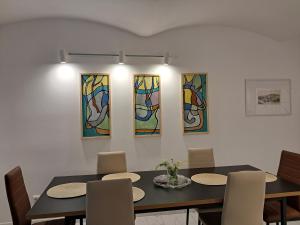a dining room with a table and four stained glass windows at Przy pałacu in Bozkow