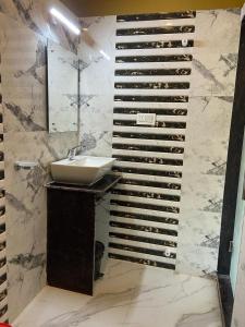 a bathroom with a sink and a wall with a wine cellar at Saikat Saranya Resort, Mandarmoni Beach in Mandarmoni