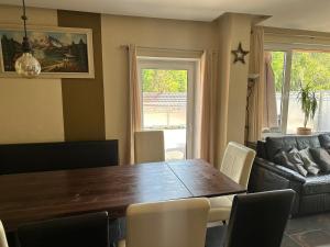 a dining room with a wooden table and chairs at Ferienhaus Am Ettersberg in Ettersburg