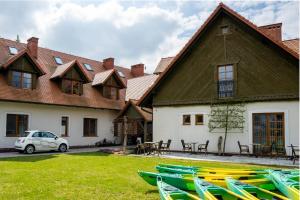 a house with a bunch of kayaks in front of it at Wrzosowe Love in Raciąż