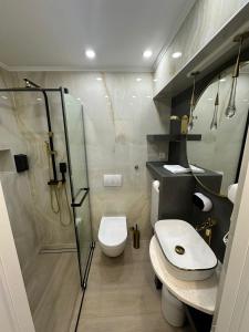 a bathroom with a shower and a toilet and a sink at Guest House Sidro in Selce
