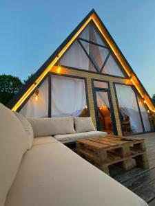 a large bed and a table in front of a house at Ashla A-Frame Lenkaran in Lankaran