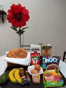 a table with a basket of food and other snacks at Cities of the World - Apartments Cusco in Cusco