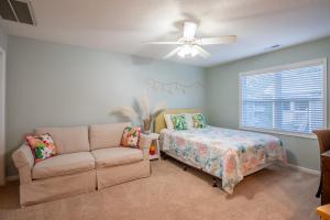 a living room with a couch and a bed at Studio in St James in Southport - great amenities in Southport