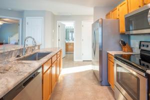 a kitchen with a sink and a refrigerator at 1 bedroom condo in St James in Southport - great amenities in Southport +16 photos