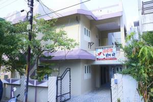 a building with a sign on the side of it at Avanti ONE 2BHK 3KM from Mahakal in Ujjain
