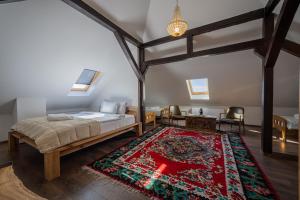 a bedroom with a bed and a red cross on a rug at Doa Boutique Hotel in Peje