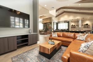 a living room with a couch and a tv at Luxe Living In Knoxville! Overlook At Farragut in Knoxville