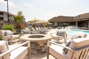 a patio with chairs and a table and a pool at Luxe Living In Knoxville! Overlook At Farragut in Knoxville
