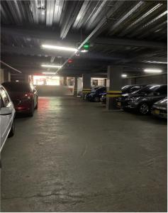 a parking garage filled with lots of parked cars at Hotel Romanza in Medellín