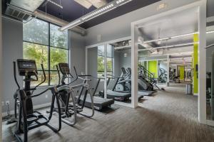 a gym with treadmills and ellipticals and exercise bikes at Park West 450 1bedroom Suite, Pool, Gym, Parking in Dallas