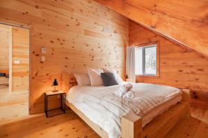 a bedroom with a bed with a teddy bear on it at Le Vertige - Ski Spa & Sauna in Saint Come
