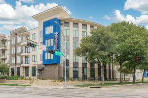 un gran edificio con una fachada azul en una calle en Stunning 1 Bedroom Condo , Pool, Gym, Parking, Cs, en Dallas