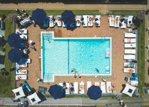 an overhead view of a swimming pool with people and umbrellas at Montauk Yacht Club in Montauk