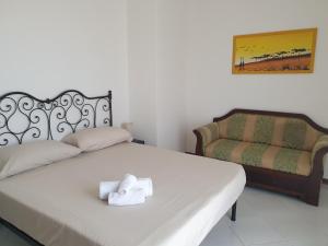 a bedroom with a bed with a towel on it at Belfiore house in Valverde